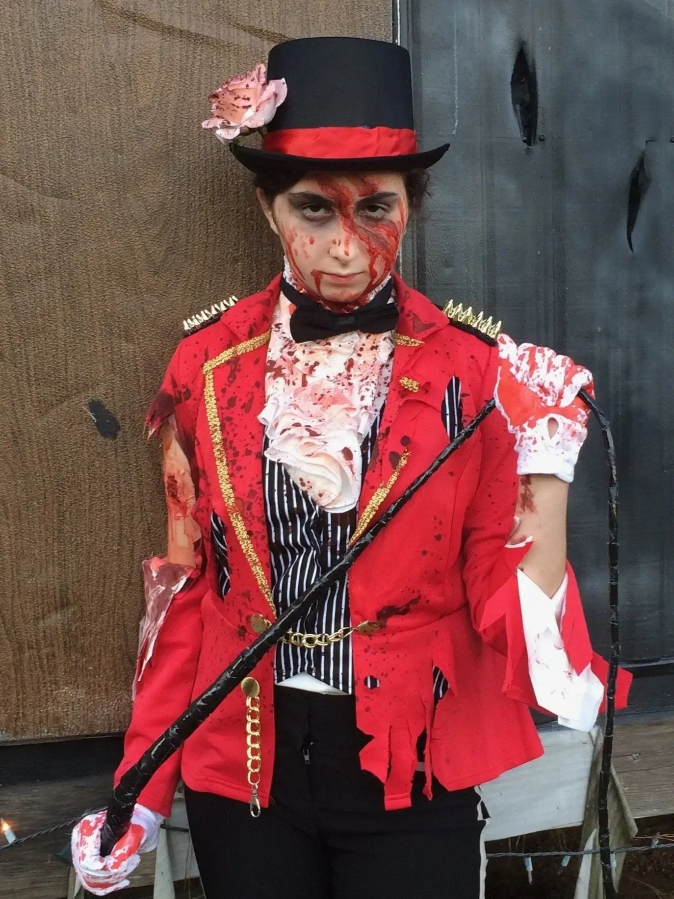 Full-length bloodied ringmaster costume with top hat and cane