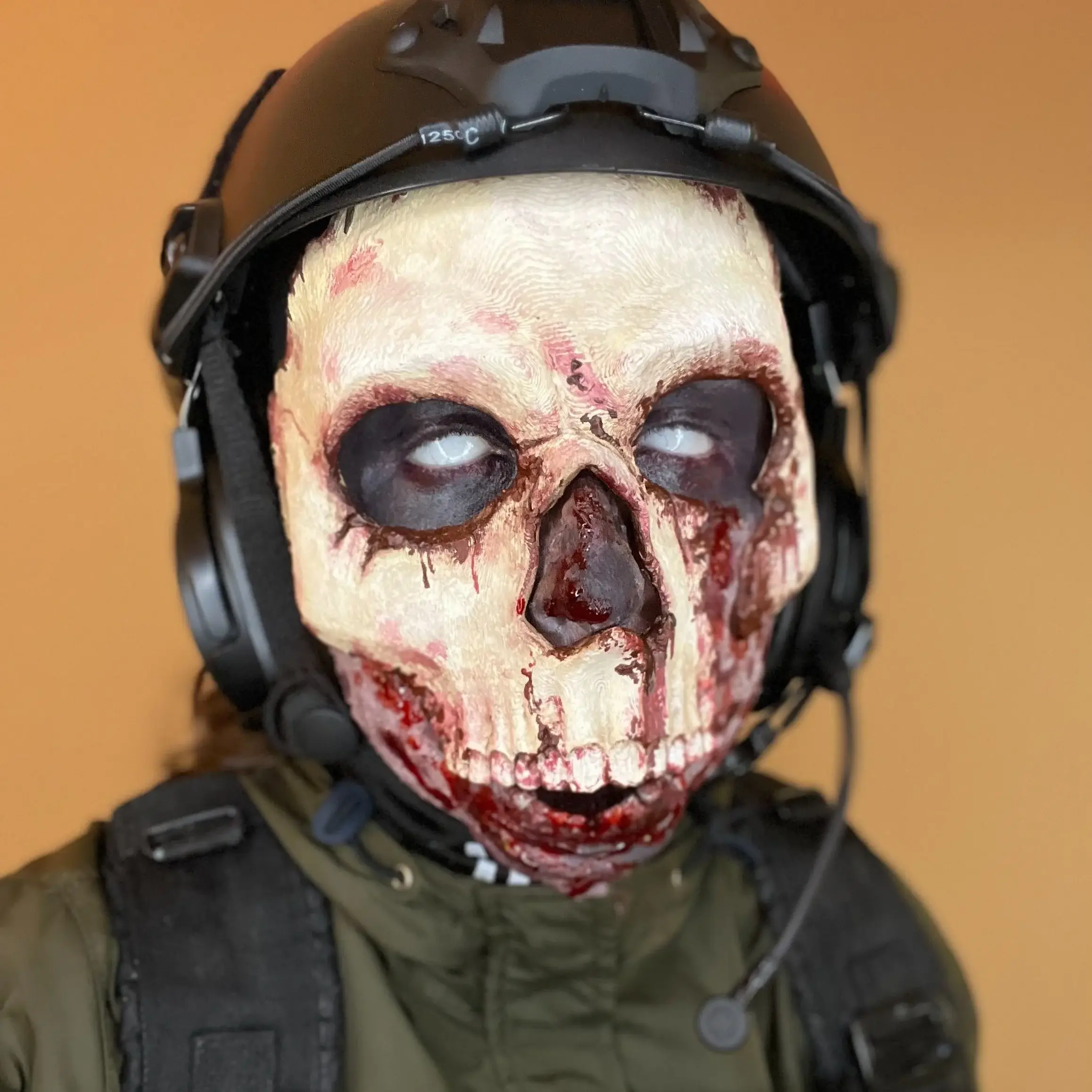Rotting skull face under a pilot helmet and headset