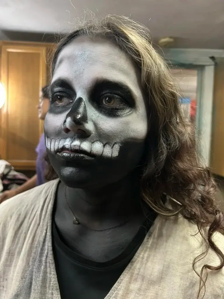 Black and white skull face paint with drawn-on teeth